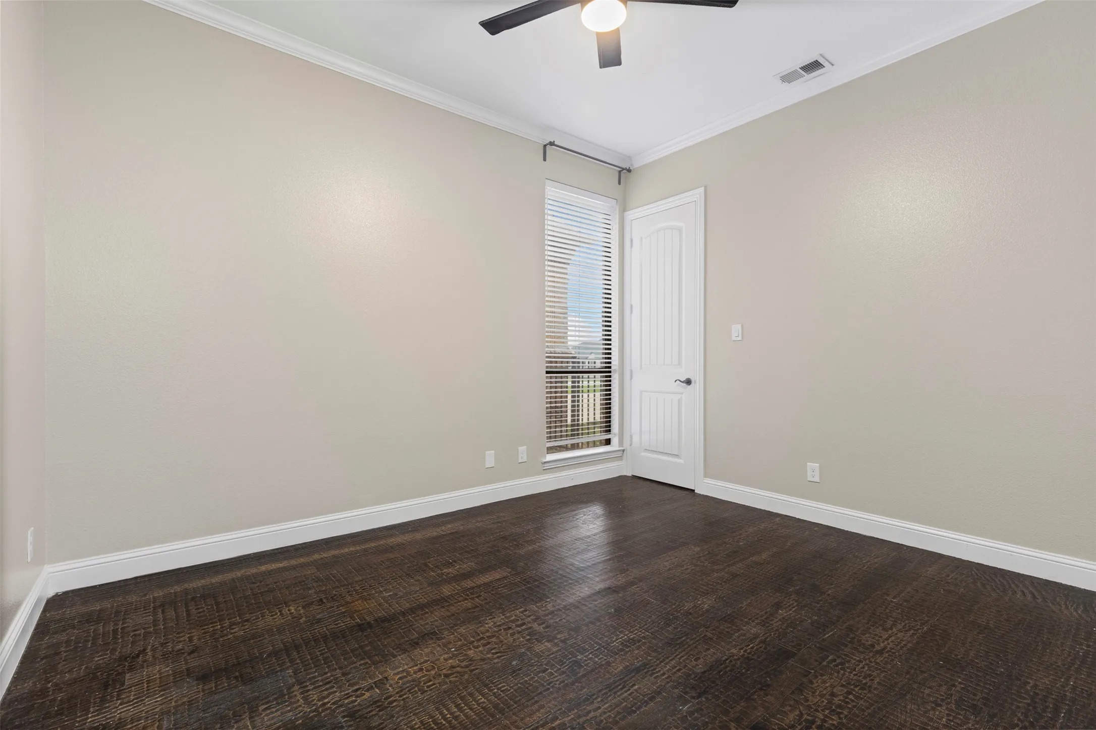Neutral-toned walls complement dark wood-finish flooring