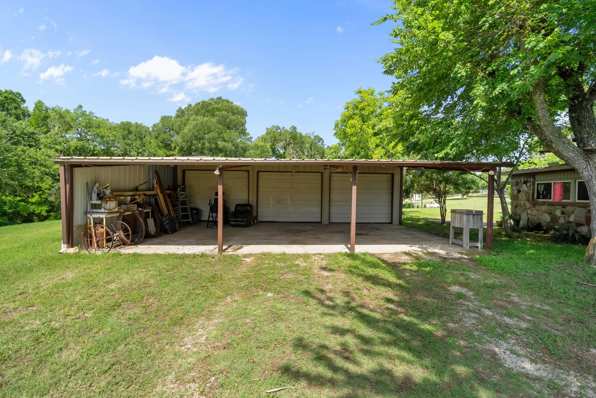 3 car garage with 3 car carport, garage has a half bath