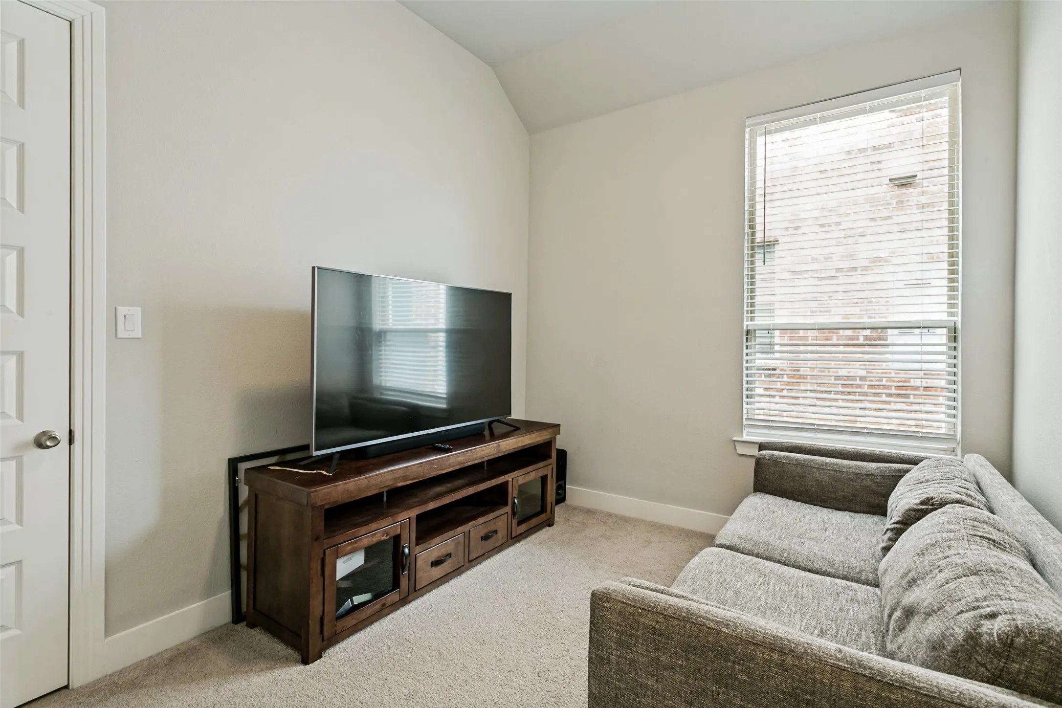Bedroom with neutral wall paint and carpeted flooring