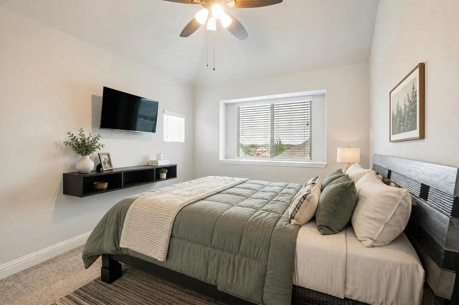 Bedroom featuring carpet flooring, a vaulted ceiling, and a ceiling fan with integrated lighting