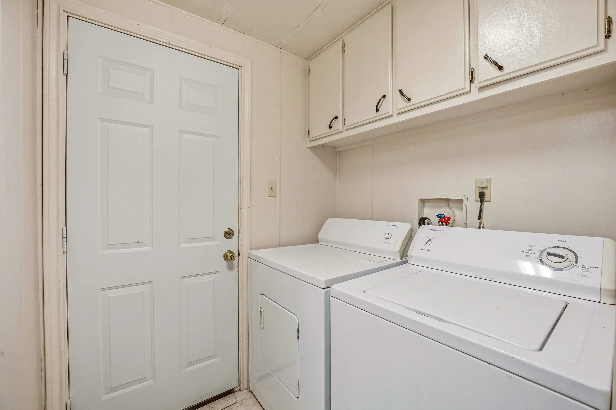 Laundry area featuring upper cabinetry with dark hardware