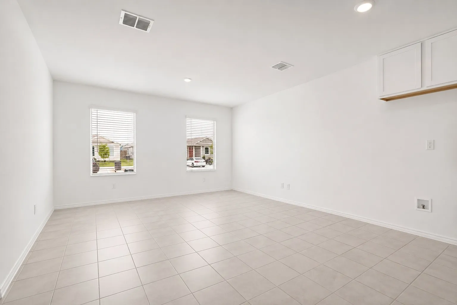 Bright interior space featuring light-toned tile flooring throughout