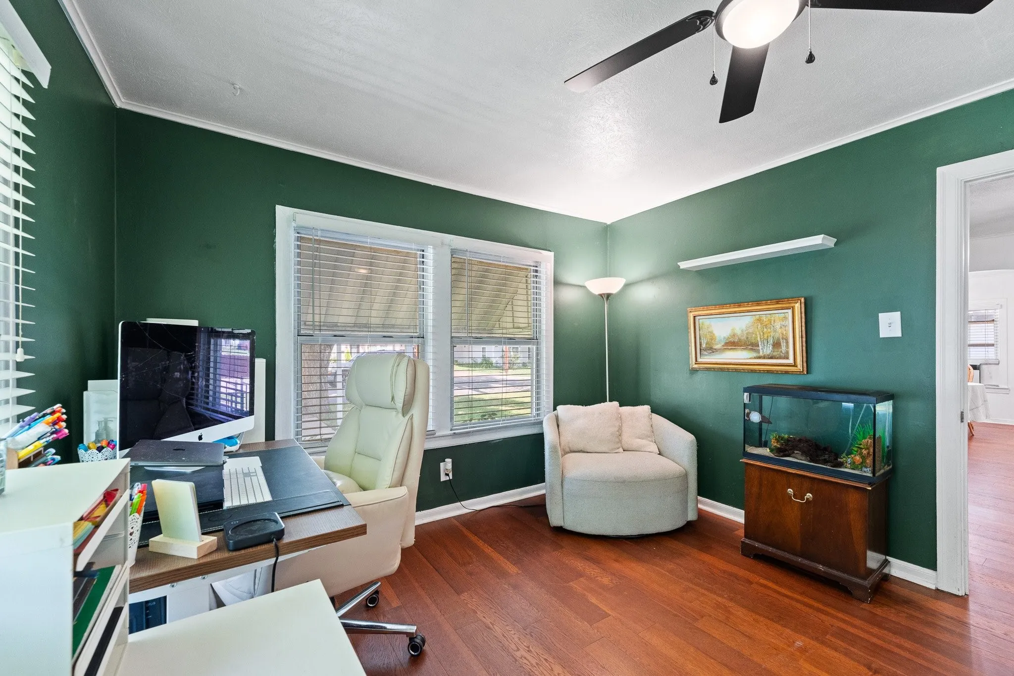 Room featuring wood-finish flooring and a ceiling fan with integrated lighting