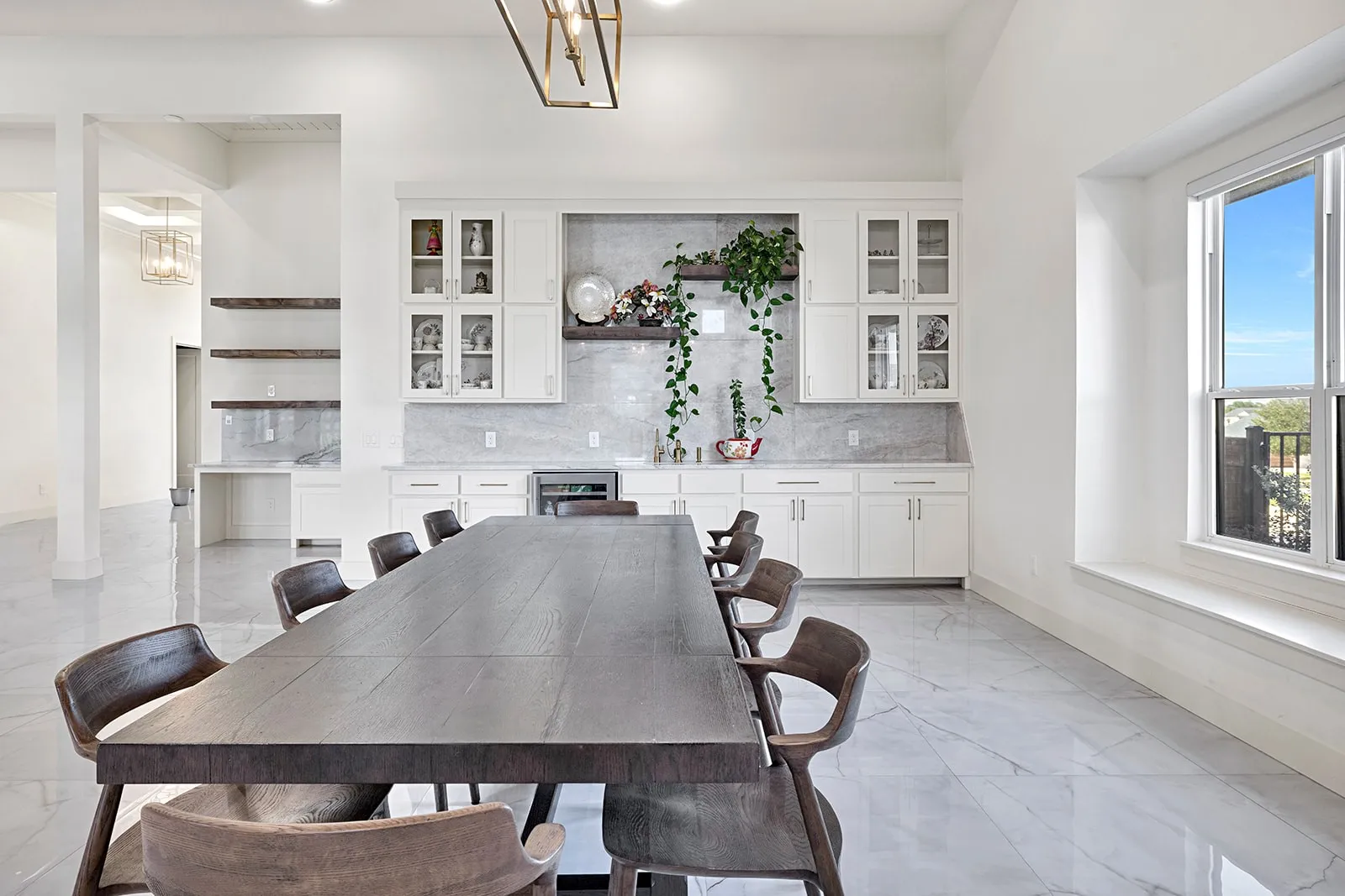 Spacious dining area featuring high ceilings and large format tile flooring