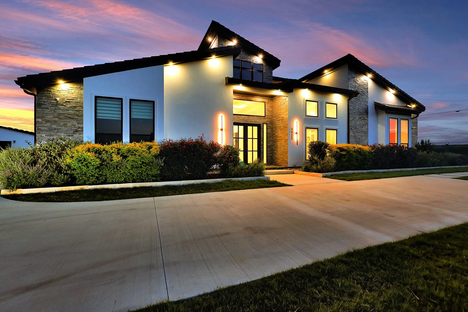 Contemporary exterior with stone veneer accents and white stucco