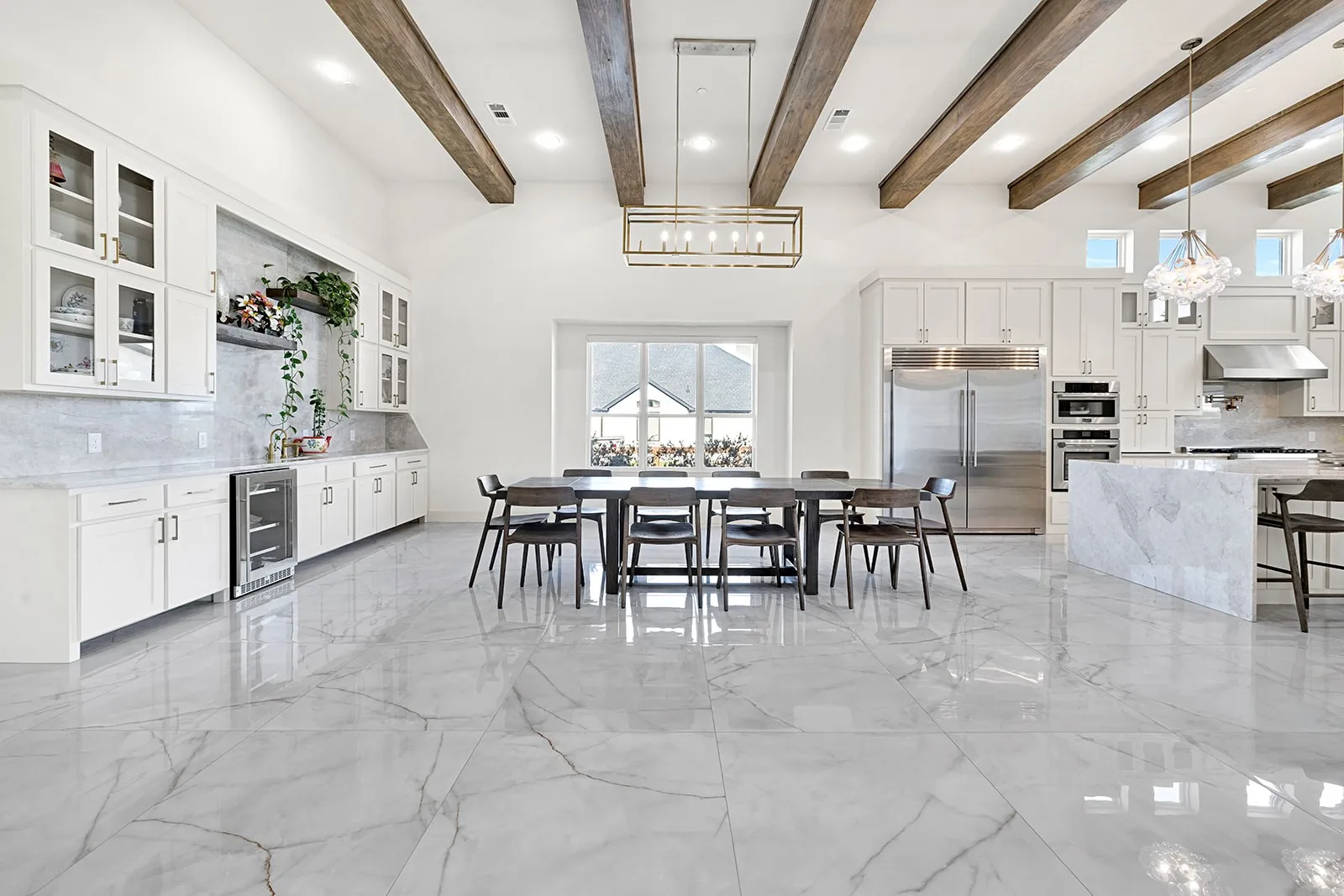 Open-concept living space featuring high ceilings with exposed wood beams