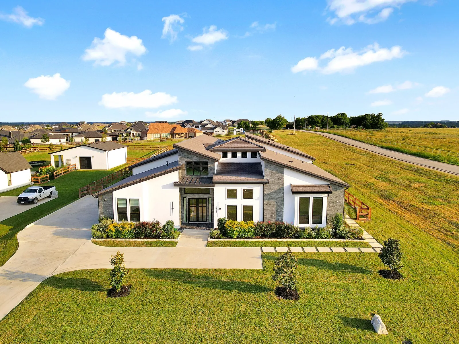 Contemporary residence featuring a multi-textured exterior with white stucco and stacked stone accents