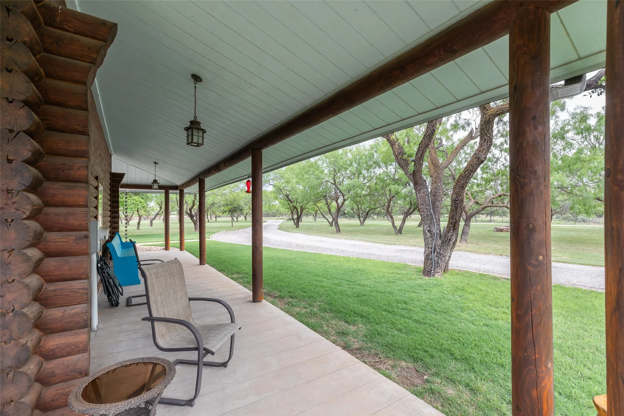 Back porch faces the shop and garage. The porches wrap all the way around this amazing home.