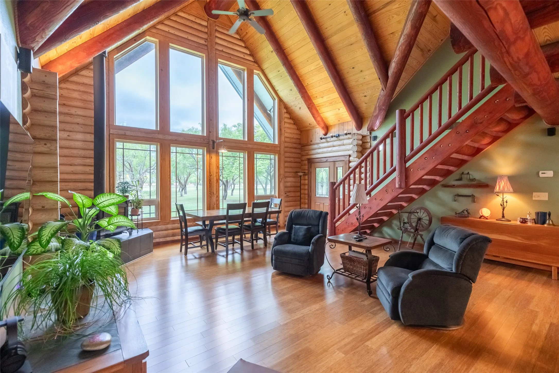 Spectaular open living area with massive windows and natural beams. Bamboo flooring, an efficient and attractive wood stove and room for everyone and everything. Even the photographer said WOW when he entered.