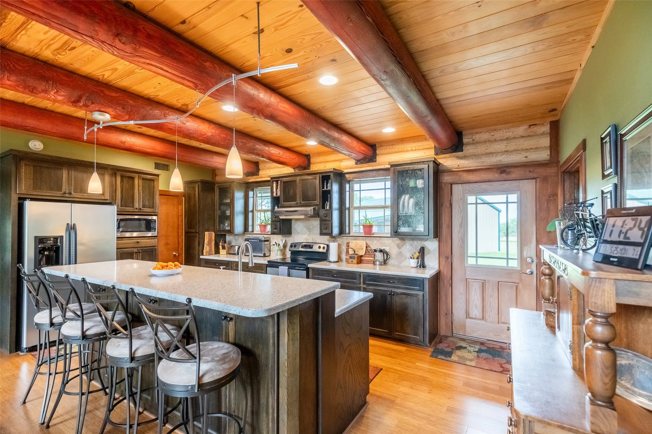 Kitchen features a bar height split level island for casual dining. Walk in pantry, a great open concept with views to the property all around you.
