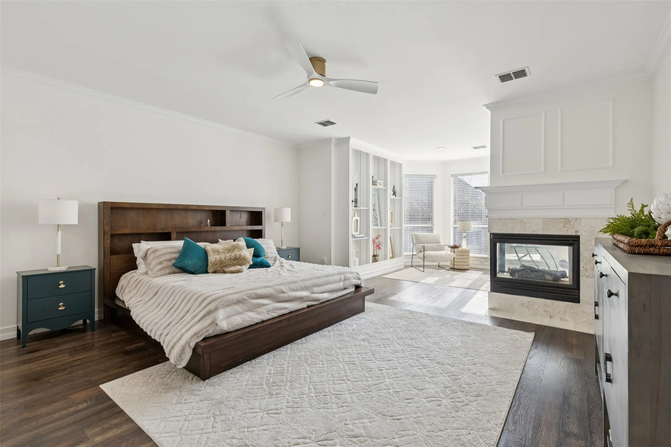 Spacious room with dark wood-finish flooring and light-toned walls