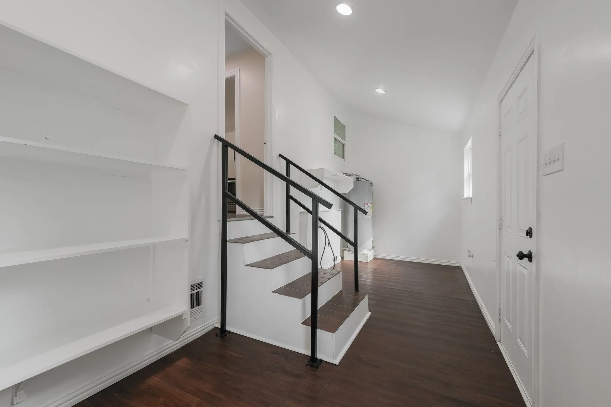 Pantry area, washer and dryer connection and water heater.