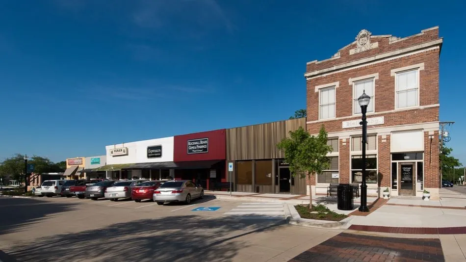 Classic brick building featuring an ornate pediment, multiple large windows, and a prominent street-level entrance