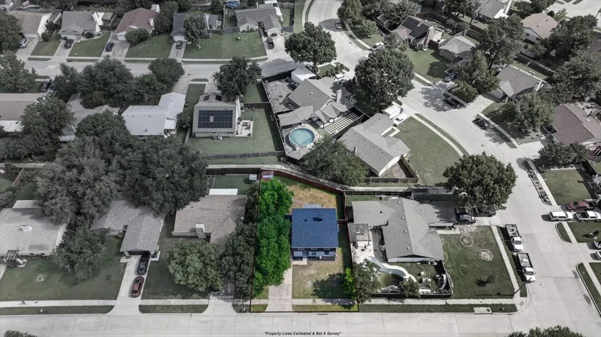 Aerial perspective showcasing a residential neighborhood with varied property sizes and mature tree coverage