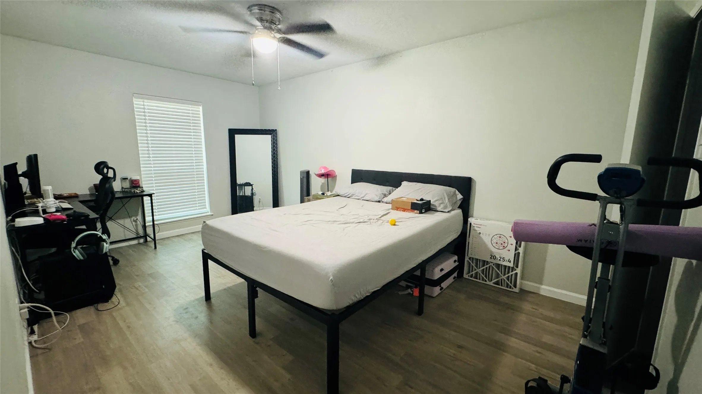 Bedroom with dark wood-type flooring and ceiling fan