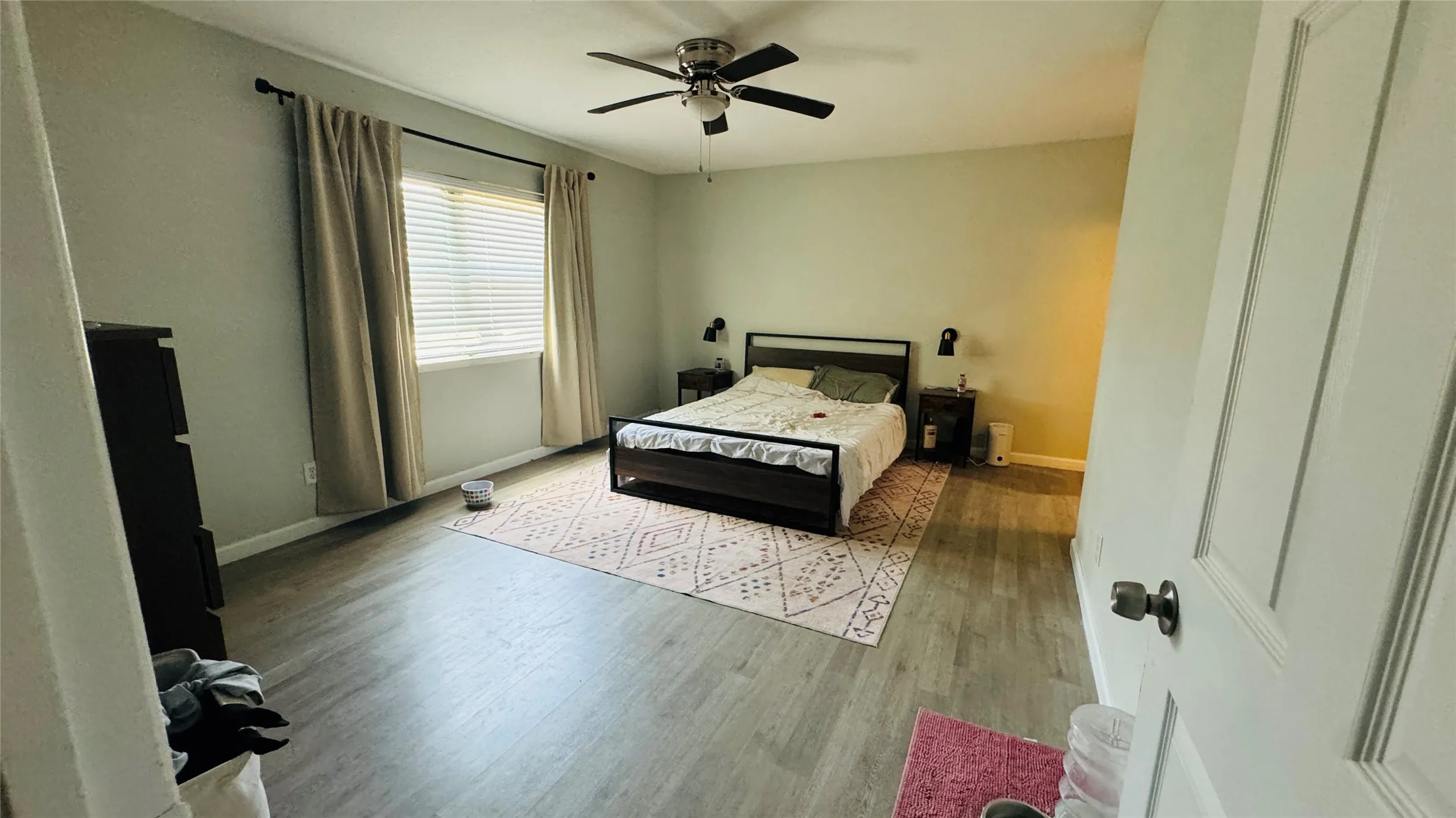 Bedroom with ceiling fan and light hardwood / wood-style floors