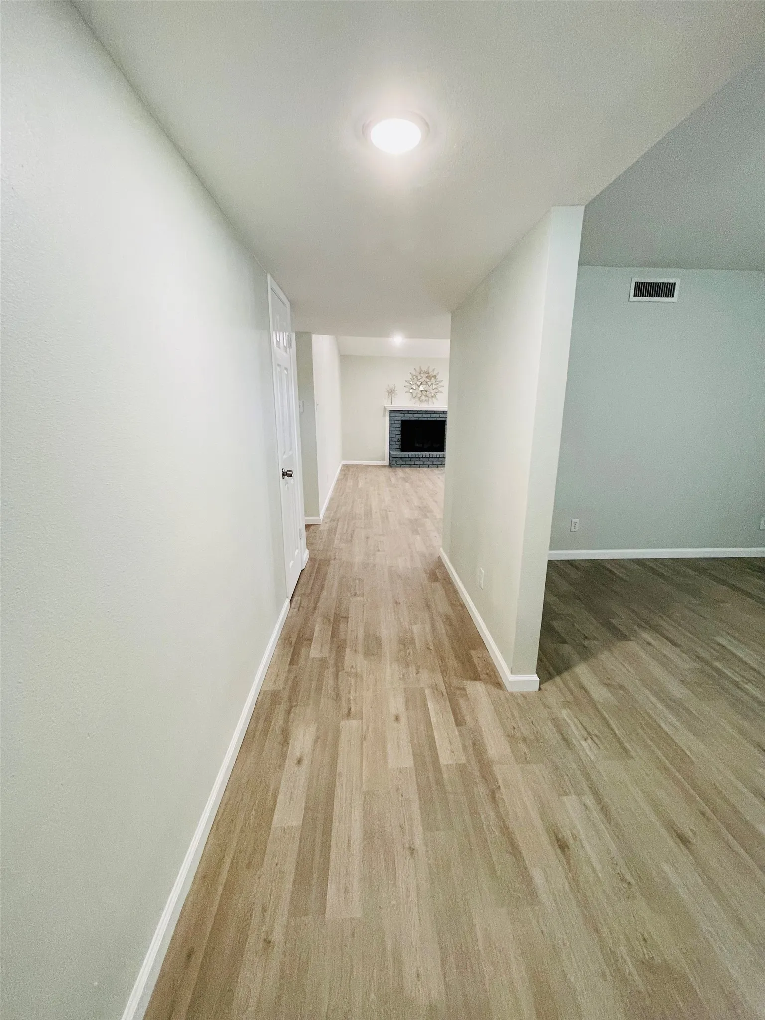Corridor with light hardwood / wood-style floors