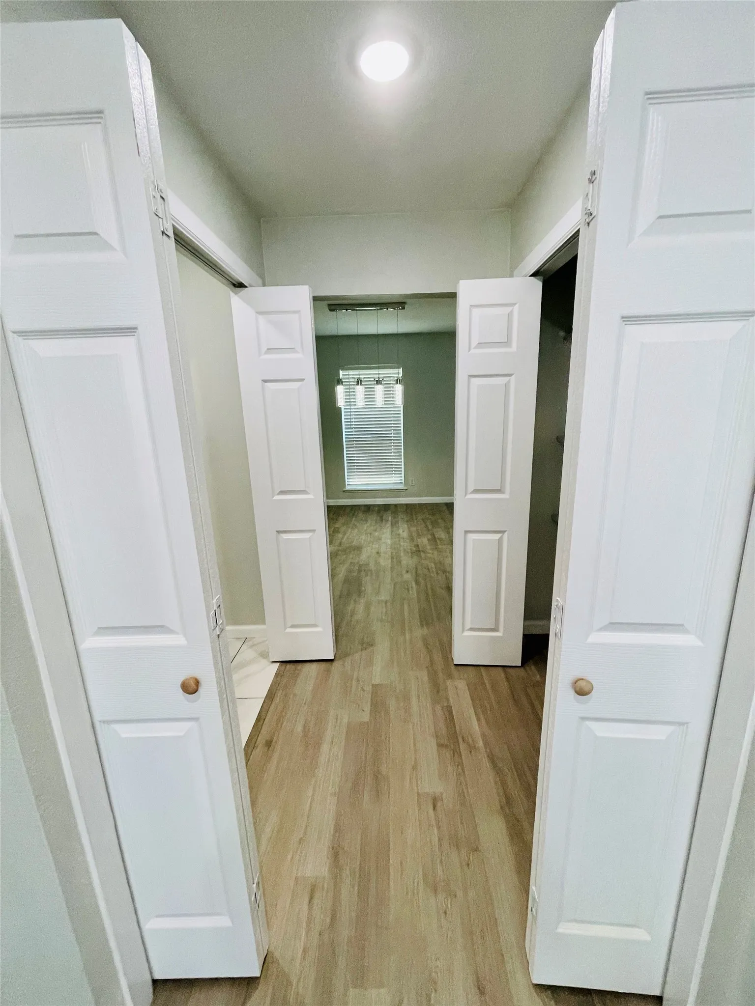 Corridor with light wood-type flooring