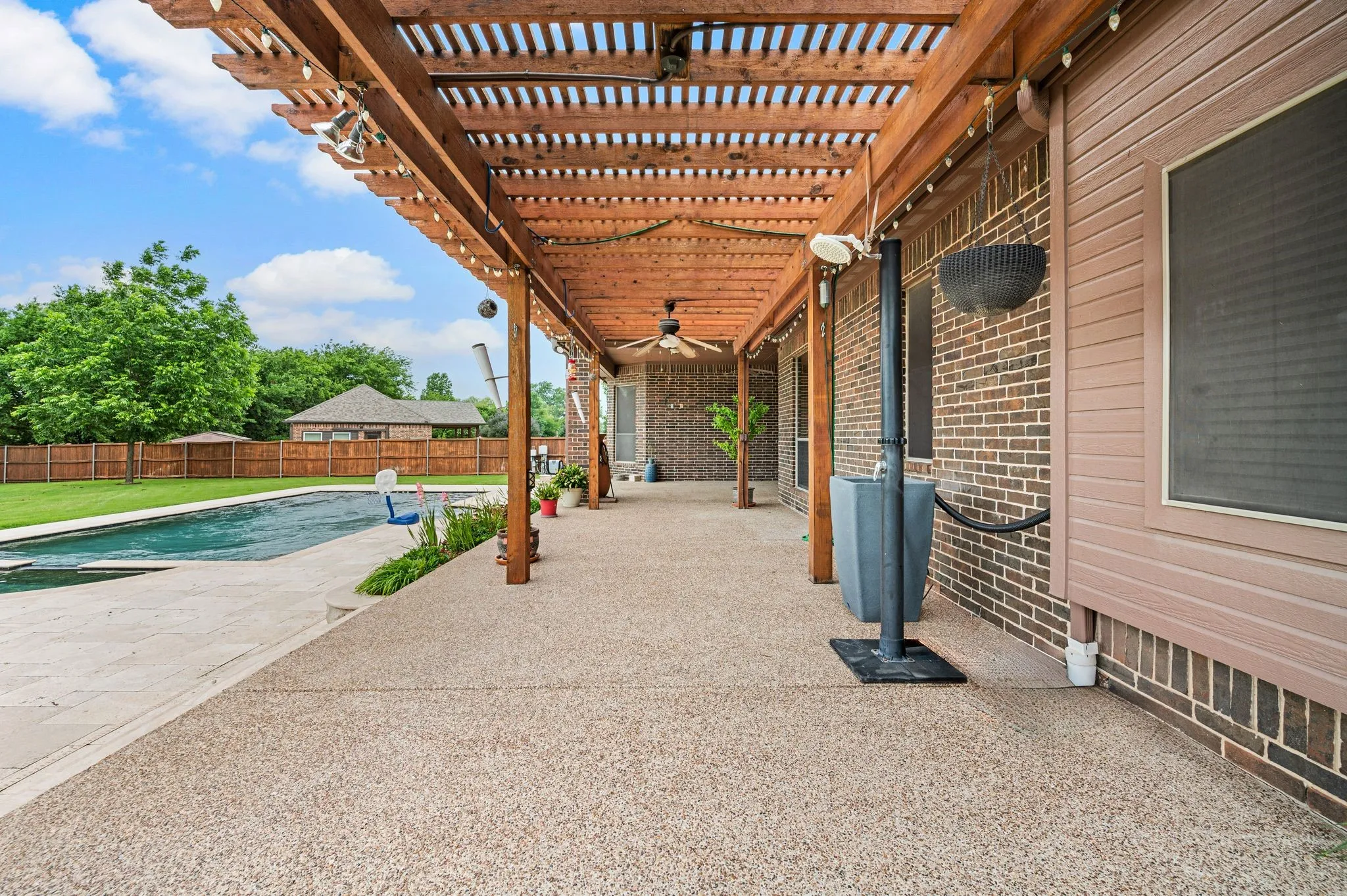 The aggregate patio is extended across the back of the home and covered by a cedar pergola. There's even a portable outdoor shower.