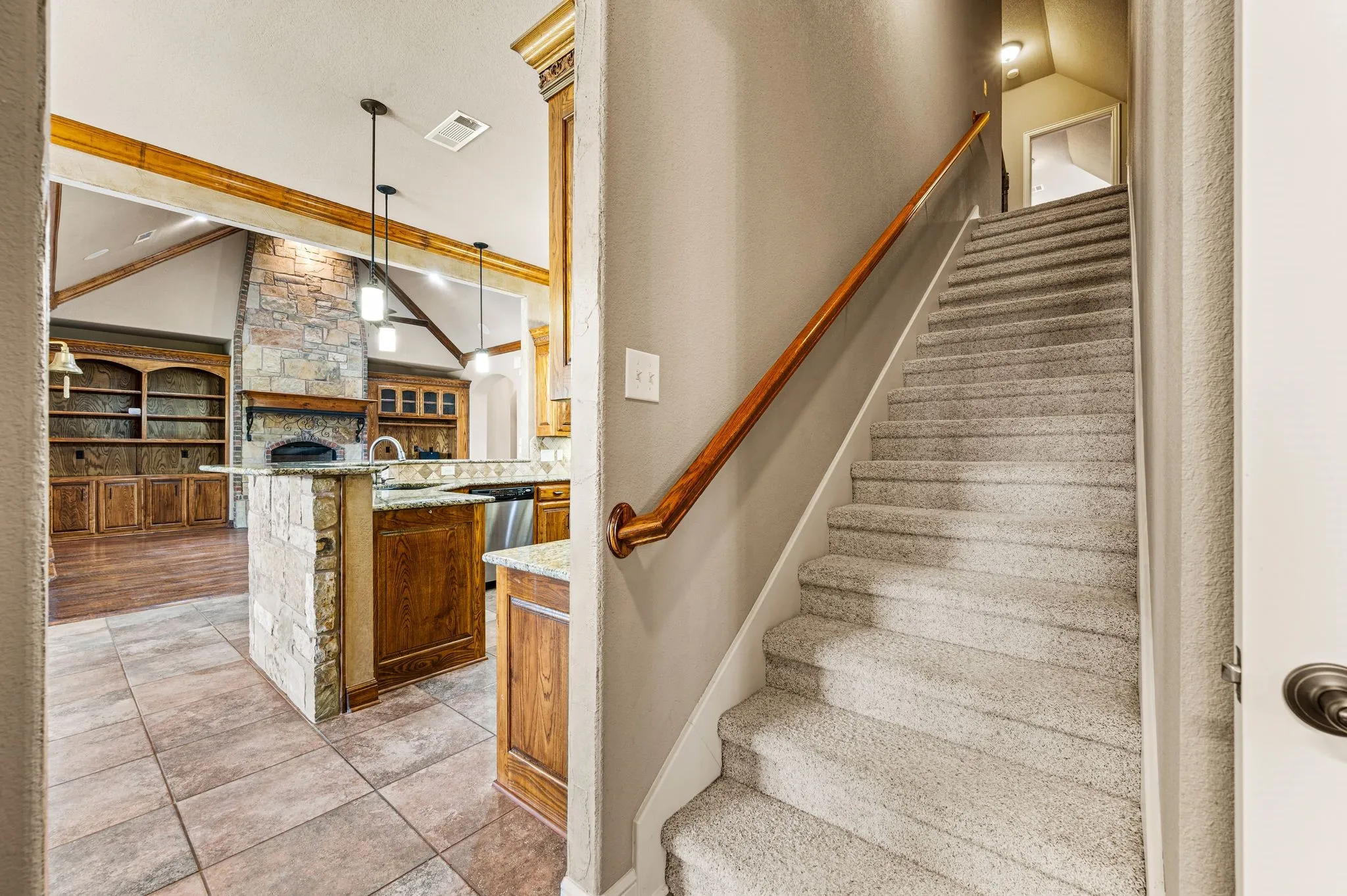 Stairwell behind the kitchen leads to a spacious game/media/rec room and half bath.