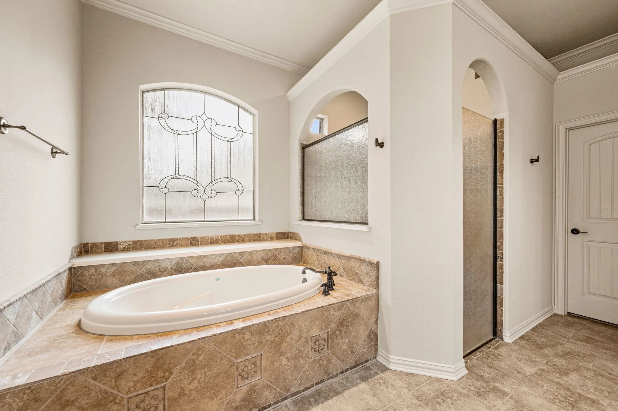 The Primary bath includes a deep soaking tub and separate walk in shower with rain glass.