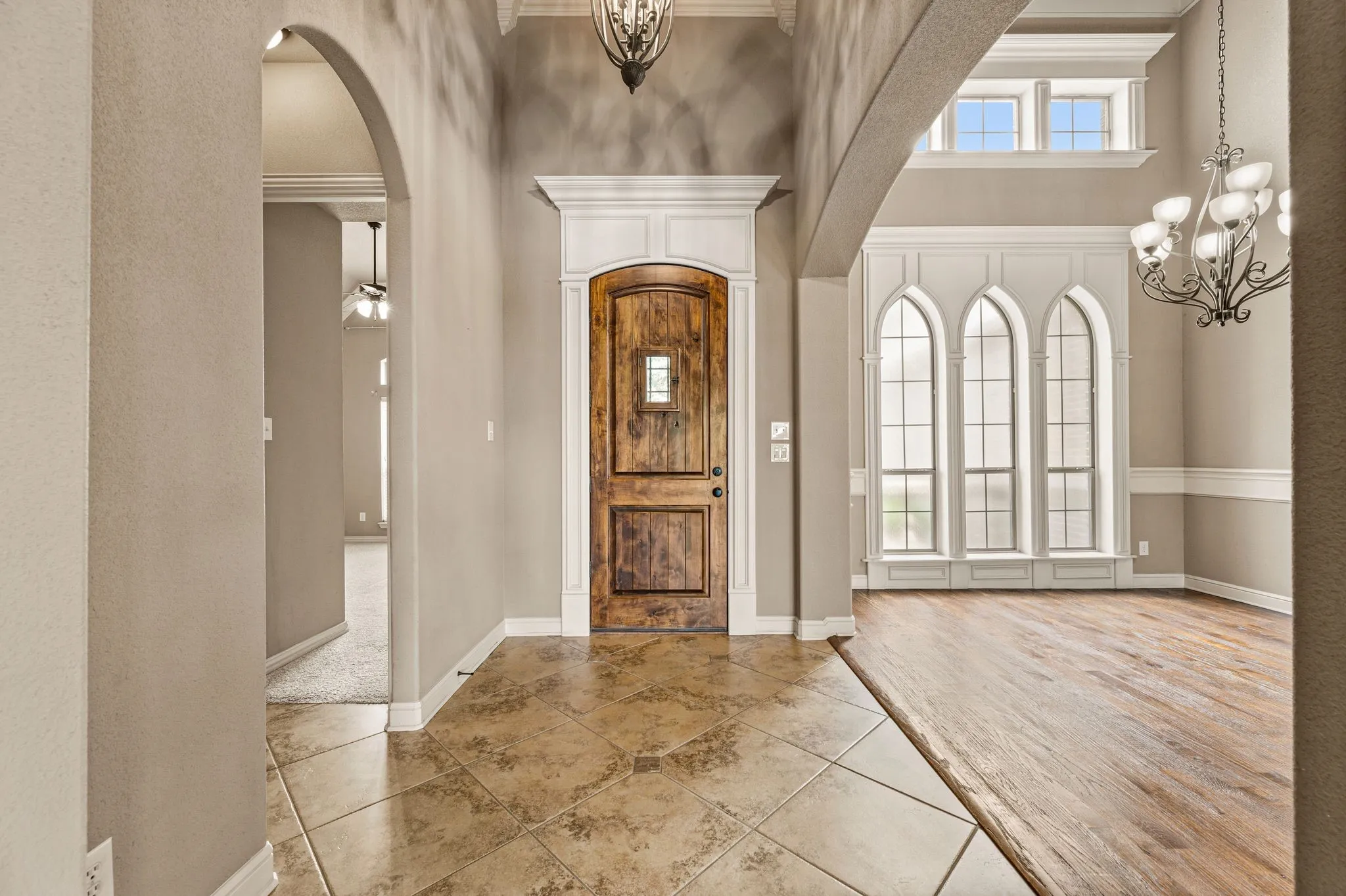 Vaulted ceilings, arched doorways and handsome architectural details compliment this interior. Impressive framing details at the front entry and windows in the dining area add a touch of elegance.