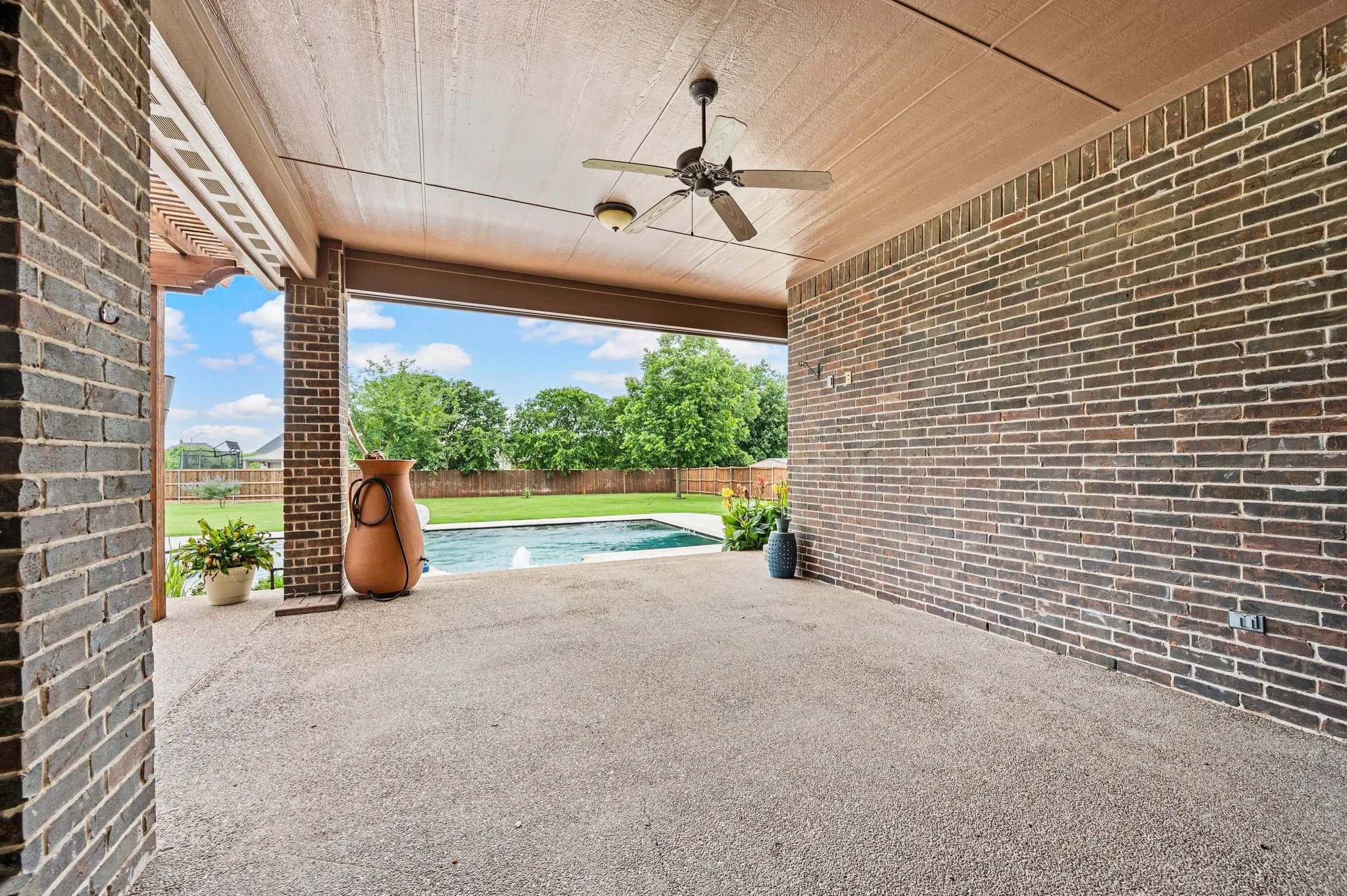 A large covered patio overlooks this huge backyard. A rain water catchment cistern is perfect for watering your potted plants.
