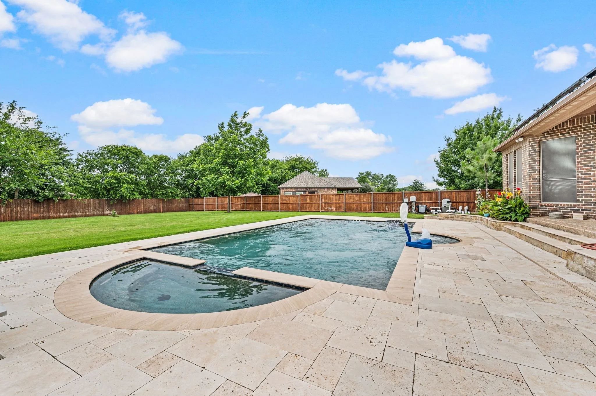This gorgeous pool and spa is surrounded by travertine decking and includes swim jets which produce an adjustable water current to maximize your exercise while swimming laps.