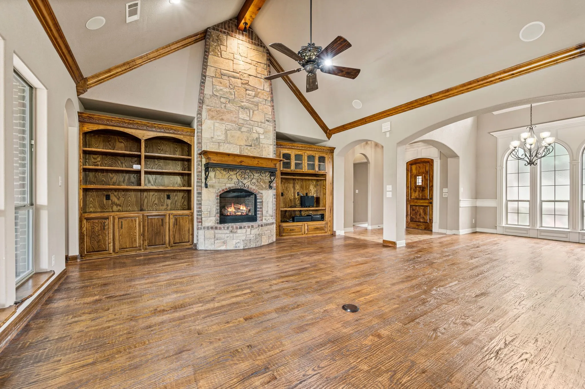 Beautiful hand scaped wood floors, solid wood built in cabinetry and a floor to ceiling stone fireplace create a stunning living room.