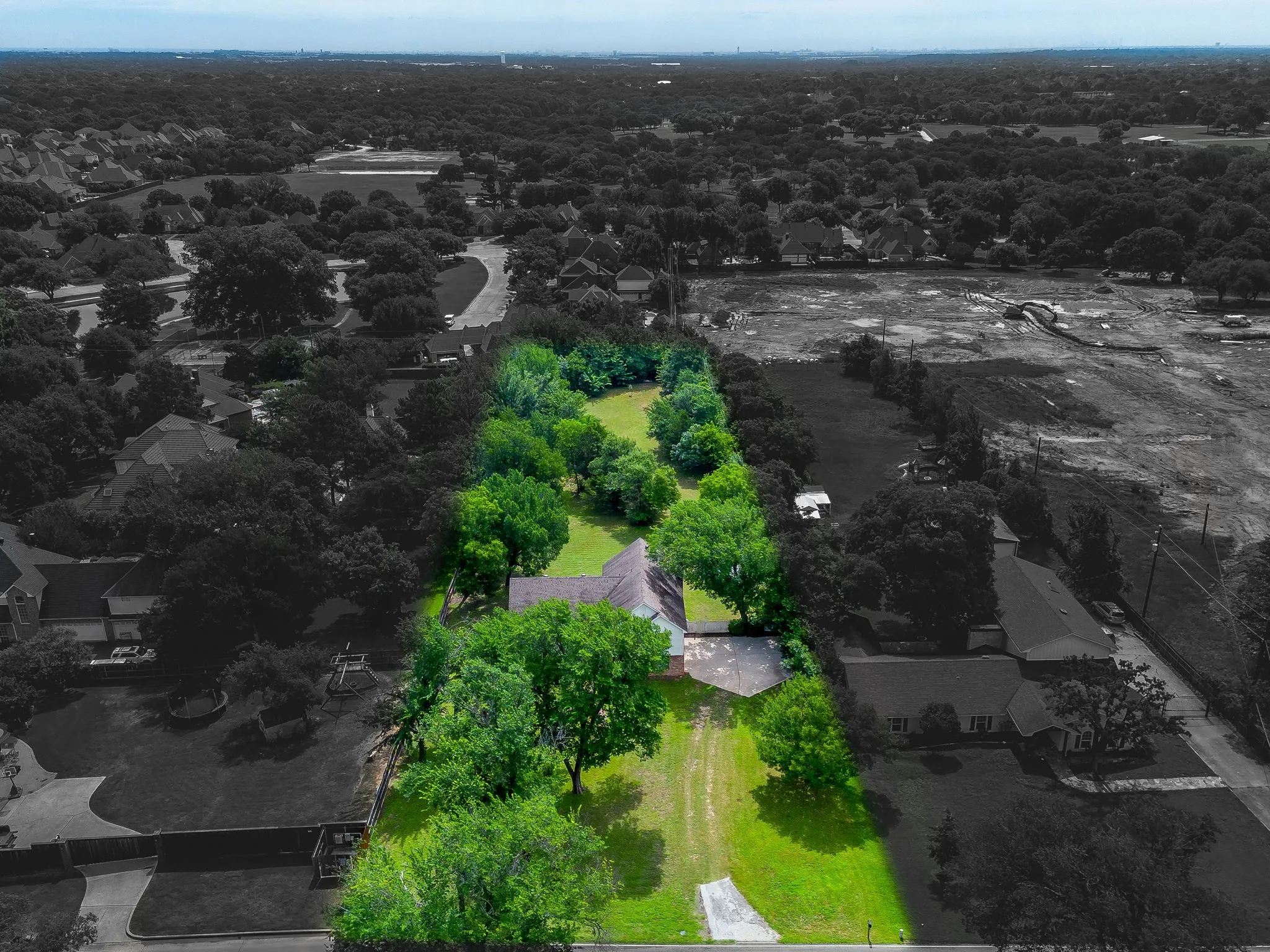 Expansive property featuring a residence, mature trees, and substantial green space