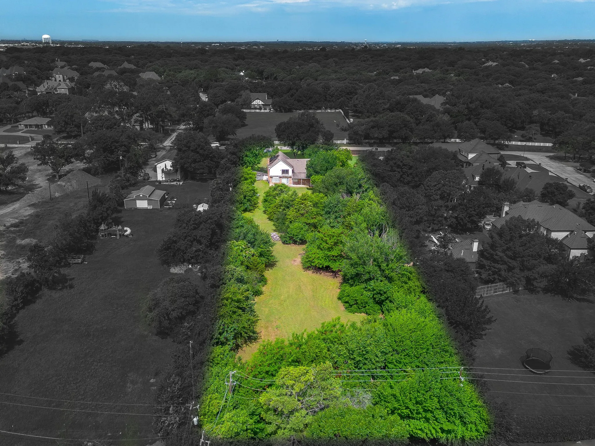 Aerial overview highlighting a generously sized property with extensive green space