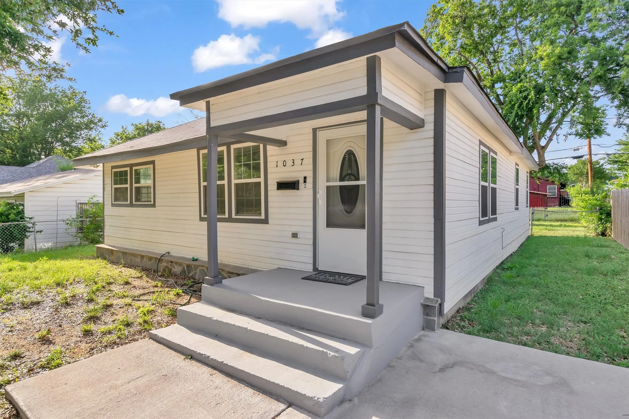 White horizontal siding exterior with dark trim