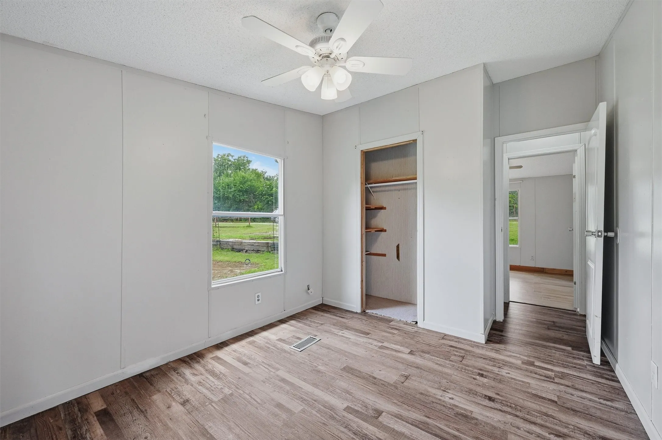 Interior room featuring wood-finish flooring and light-toned walls