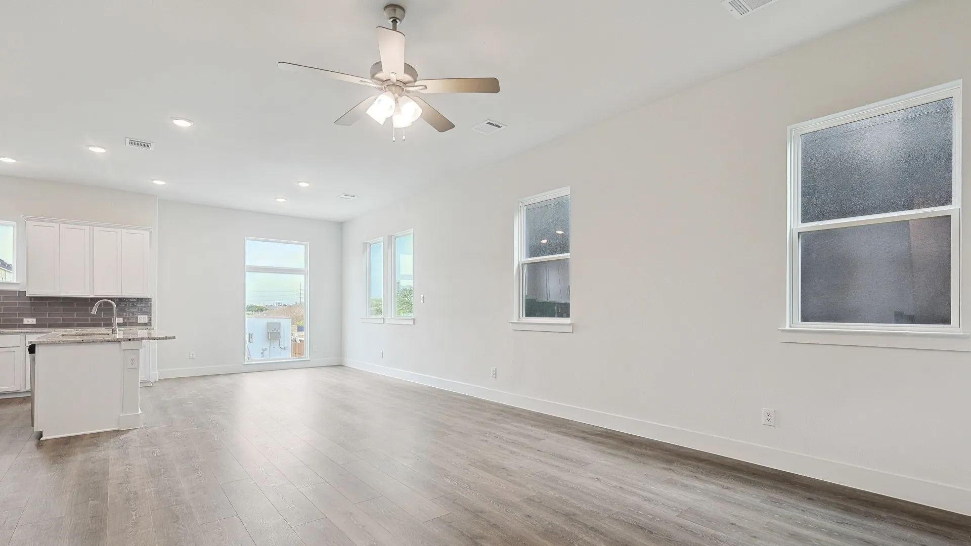 Open-concept living area with wood-finish flooring