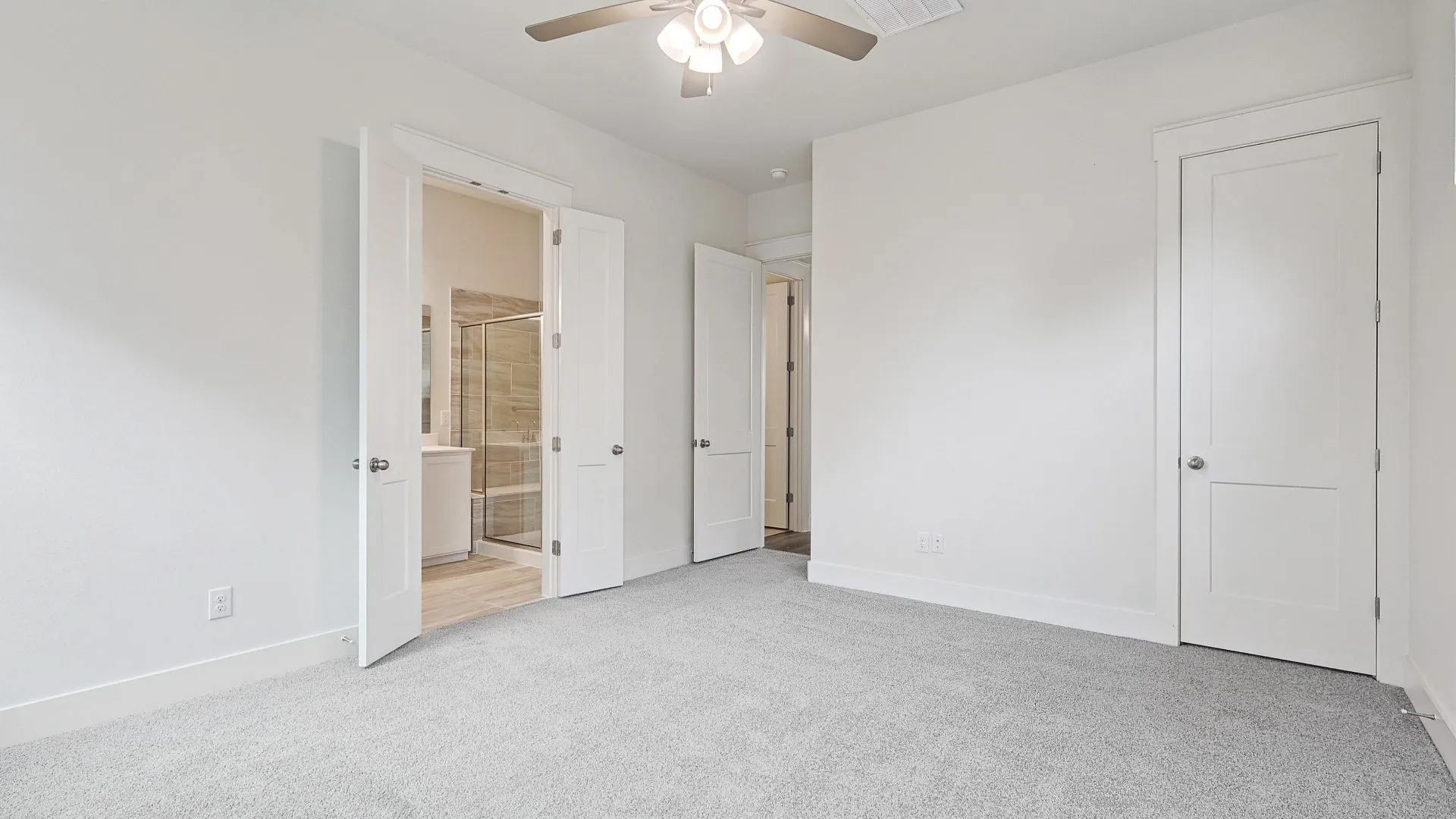 Carpeted room with a ceiling fan, white walls, and white trim