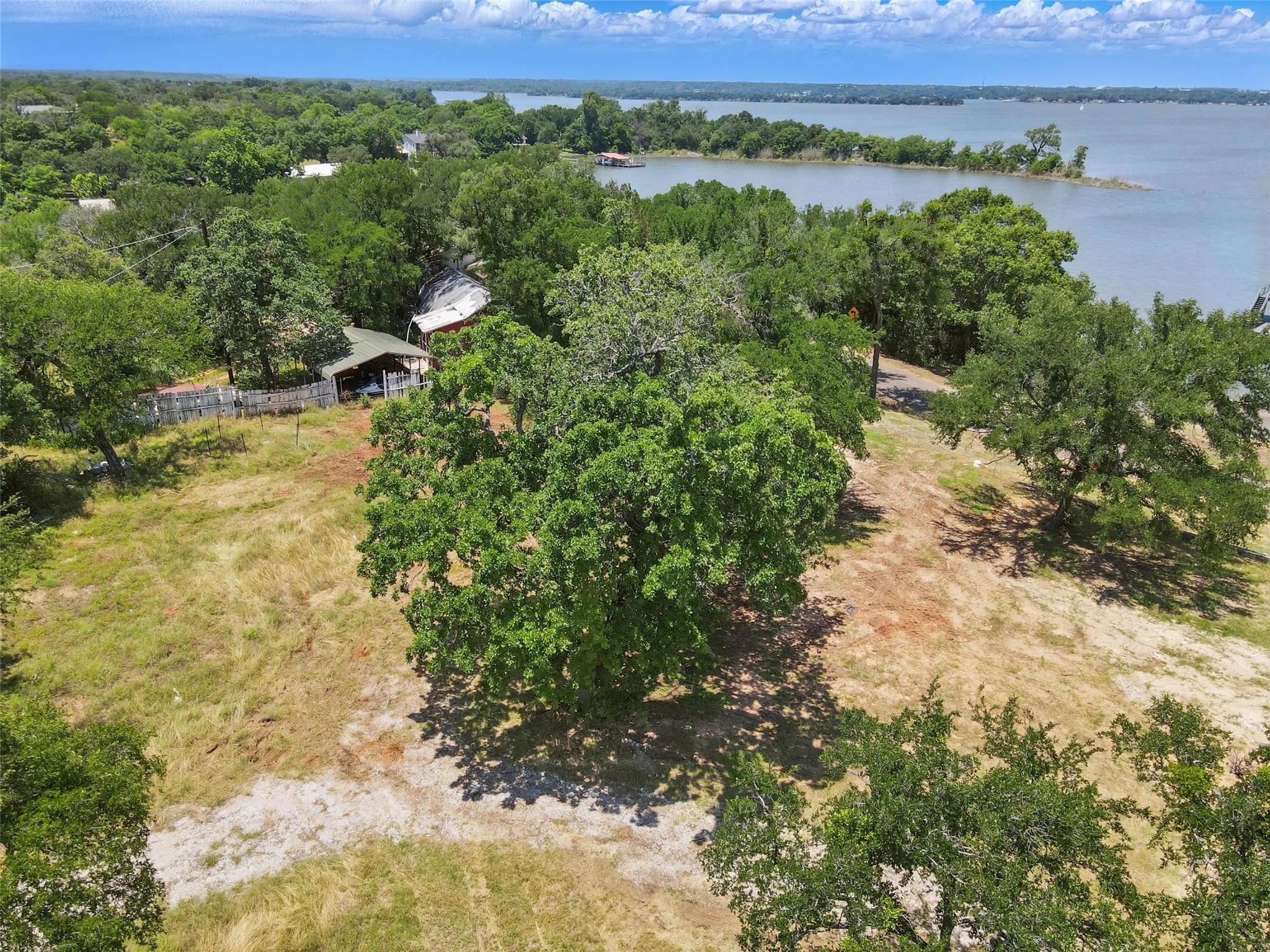 Drone / aerial view of a nearby body of water and a forest