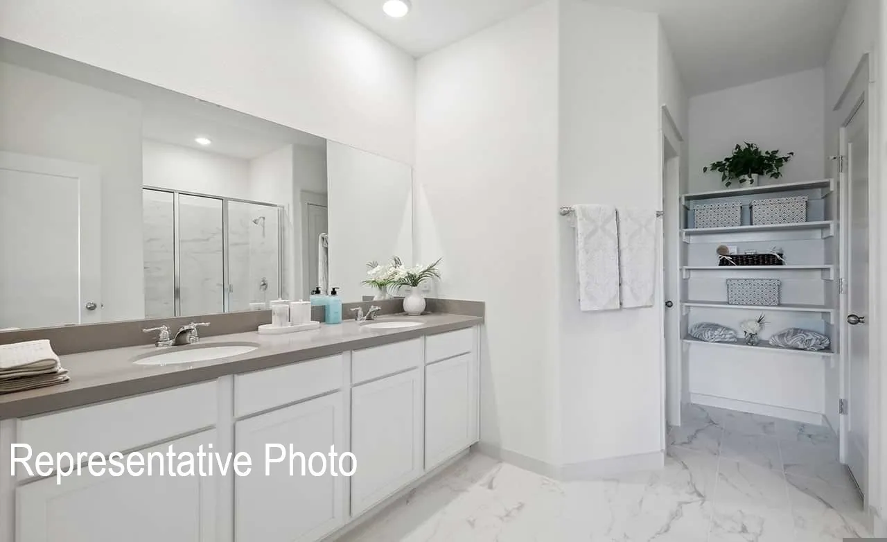 Spacious bathroom featuring a double vanity with undermount sinks and a wide mirror