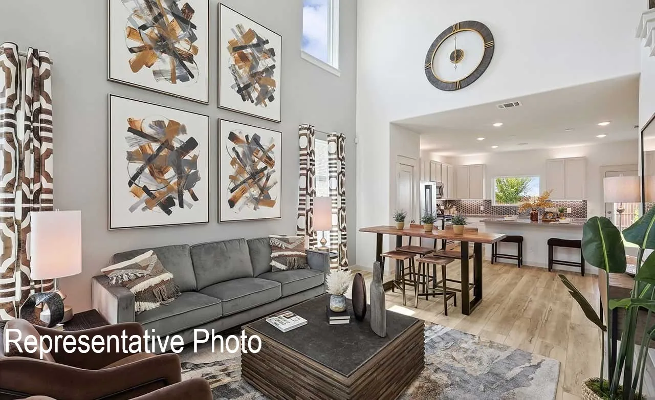 Vaulted ceiling living area with wood-finish flooring, recessed lighting, and an open concept layout