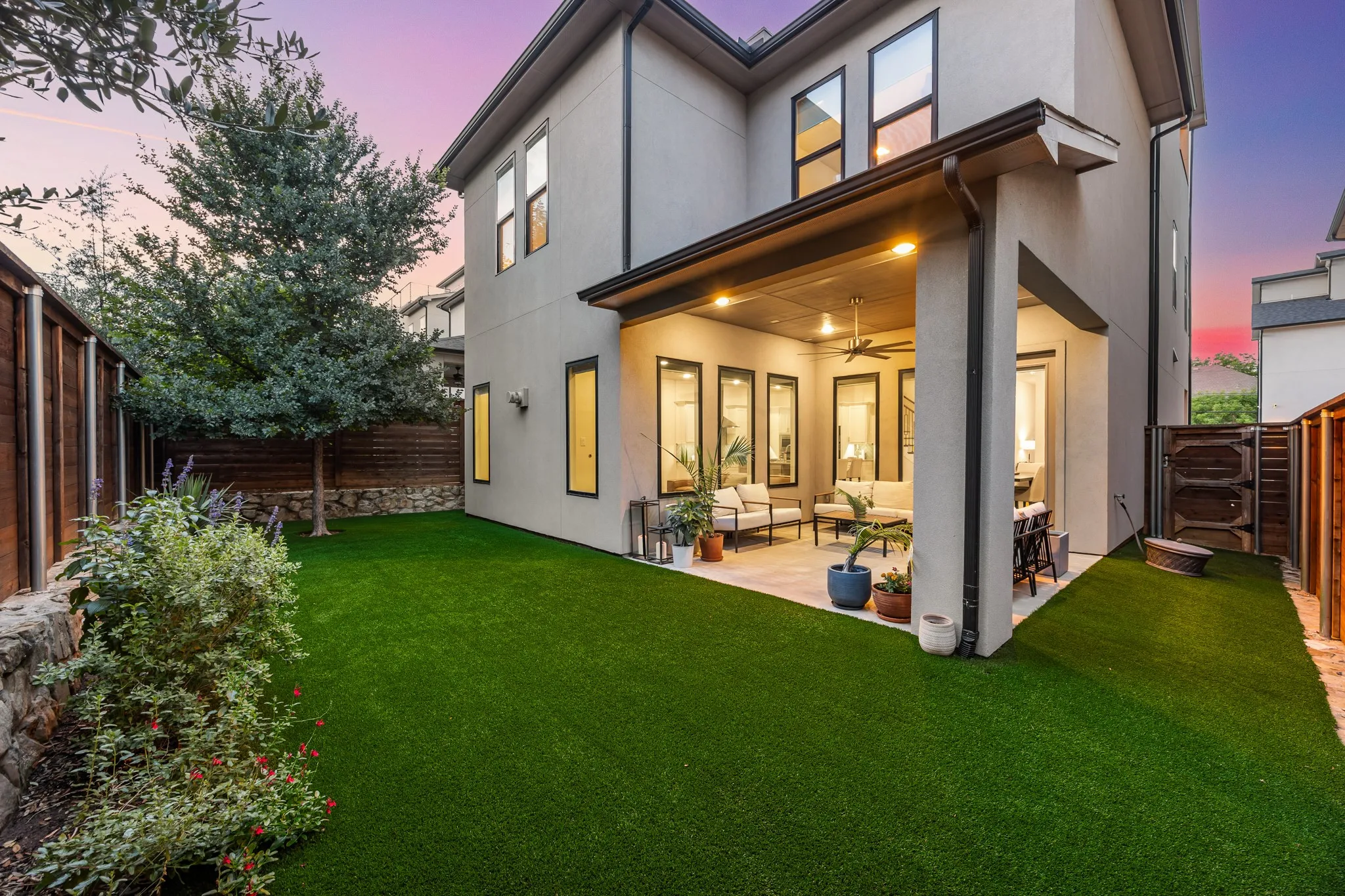 Stunning backyard with covered patio and turf.