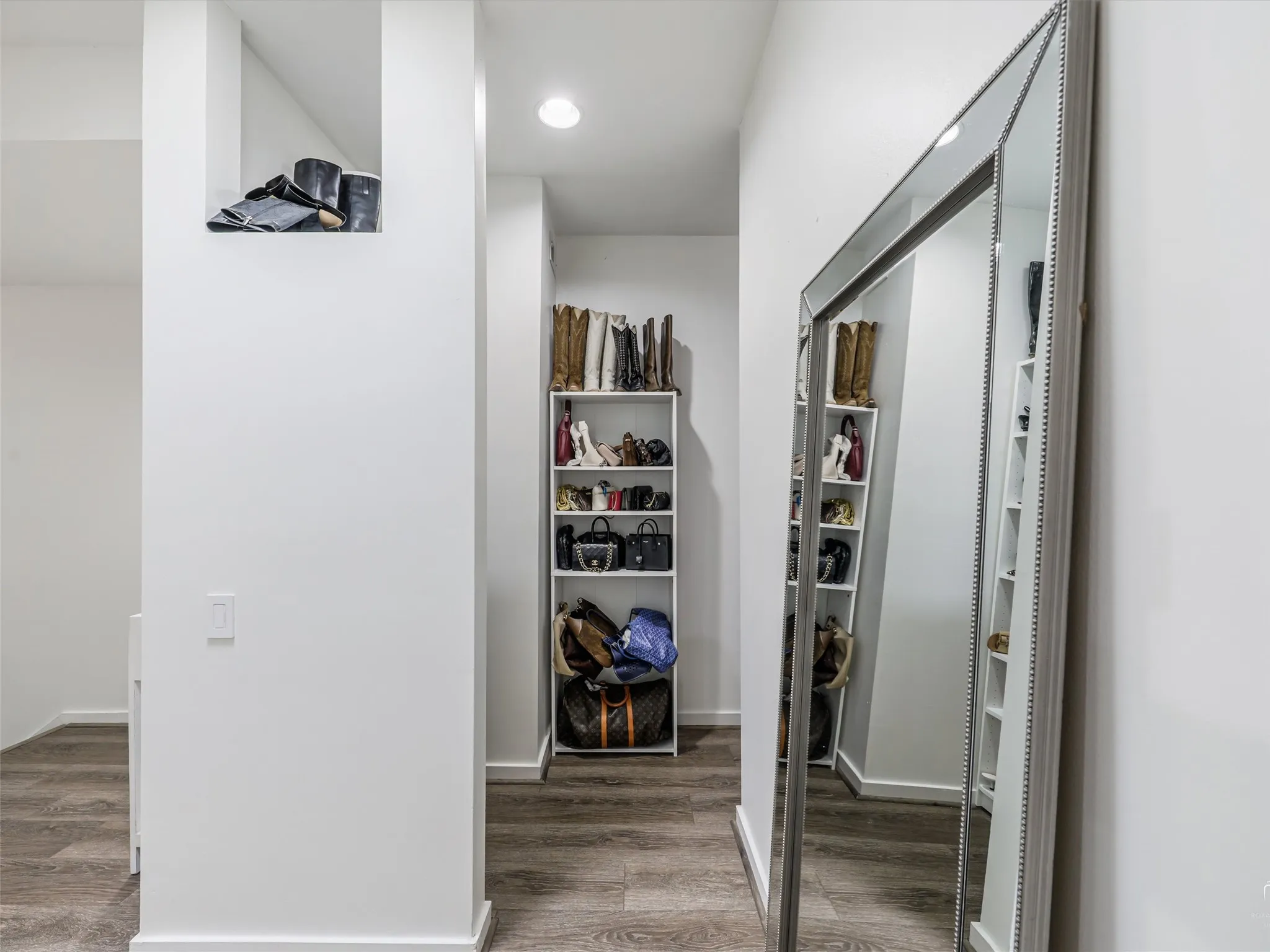 Primary Closet featuring wood-finish flooring and recessed lighting