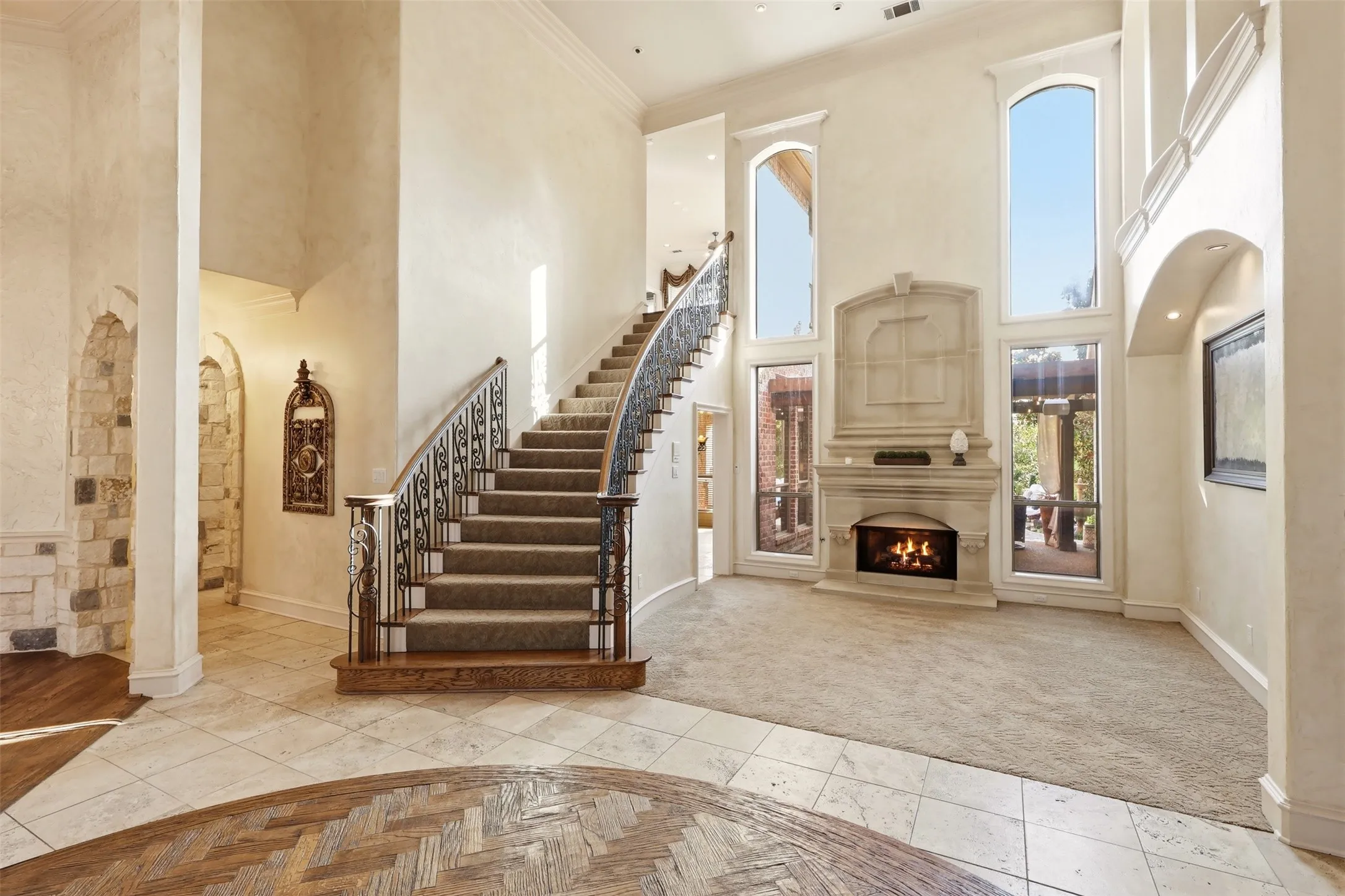 Formal entry and sitting area with cast stone gas fireplace