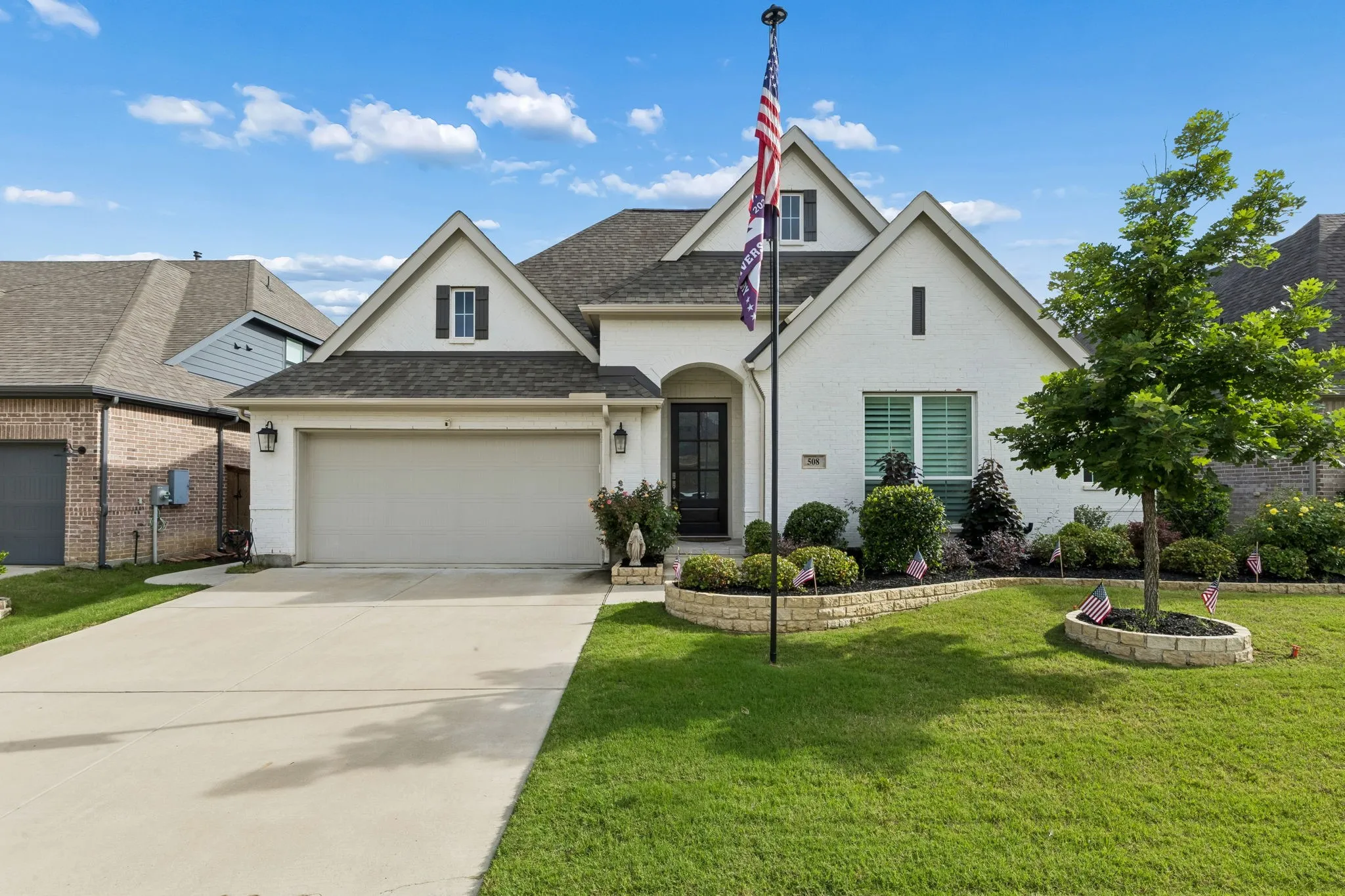 Contemporary residence featuring a light-colored brick exterior with dark trim accents