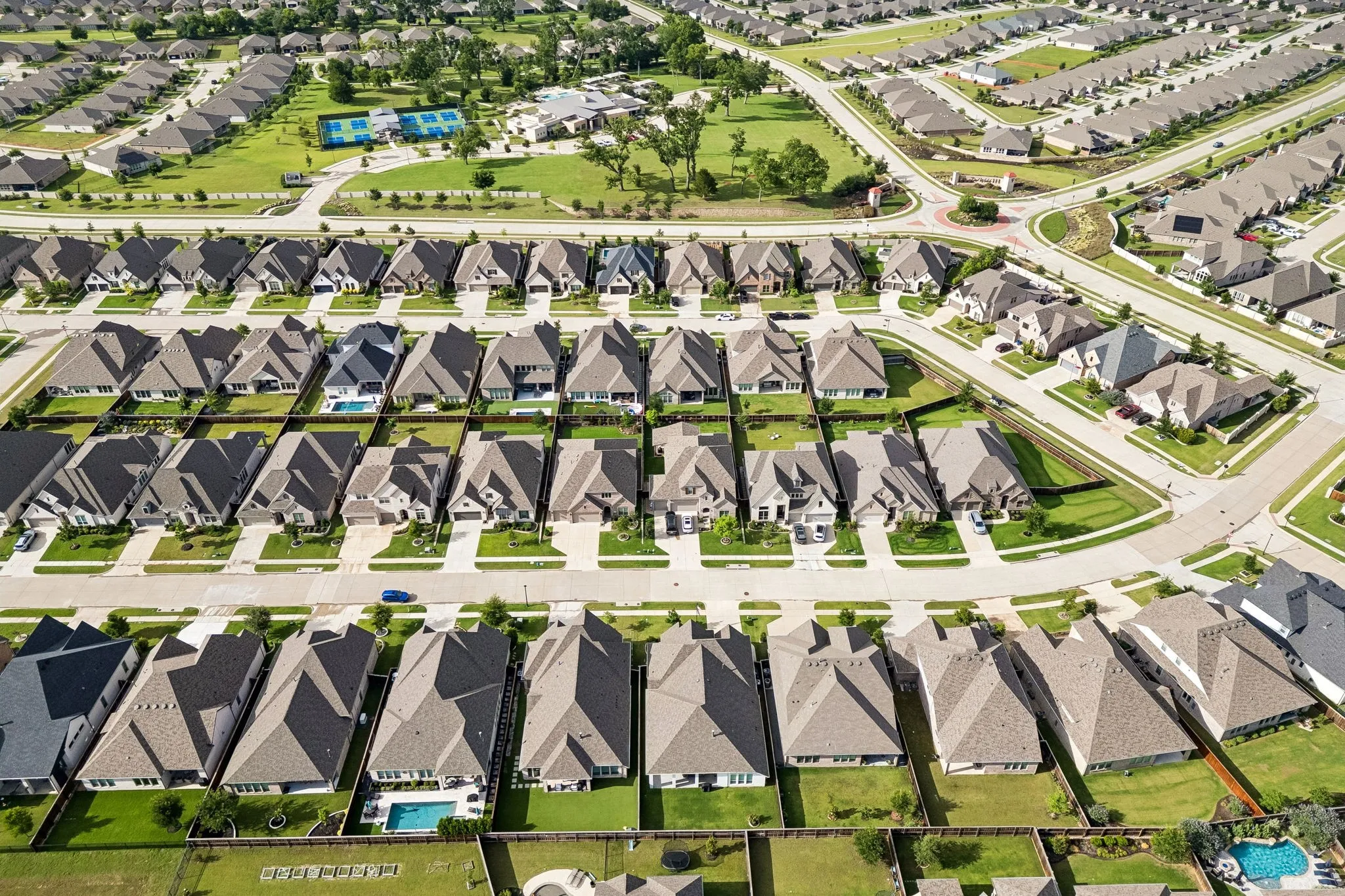 Expansive aerial view showcasing a residential community with numerous single-family homes