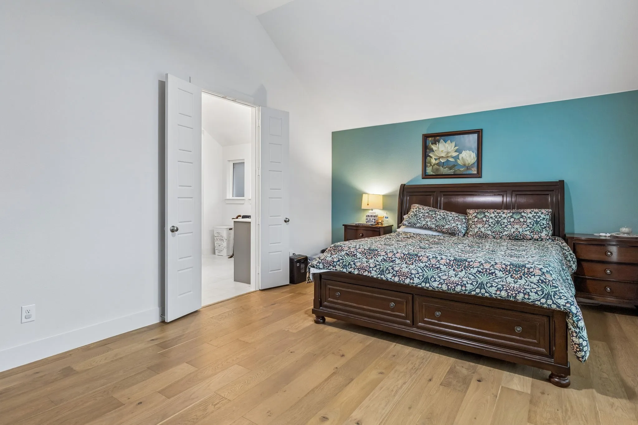 Room featuring light wood-finish flooring and vaulted ceilings