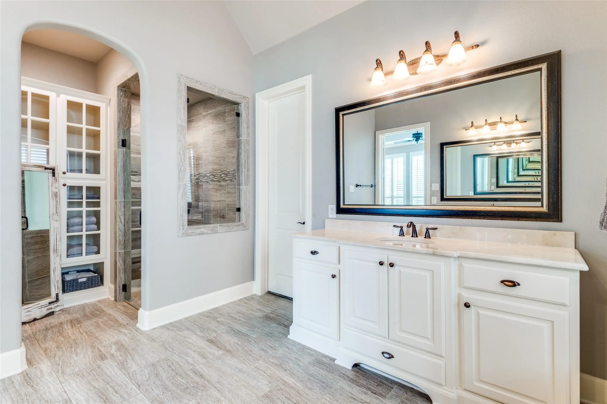 The spacious walk-in shower showcases beautiful tilework and glass enclosure, providing a relaxing retreat for everyday indulgence. Adding to the appeal is an oversized walk-in closet, offering generous storage and organization for even the most extensive wardrobe.