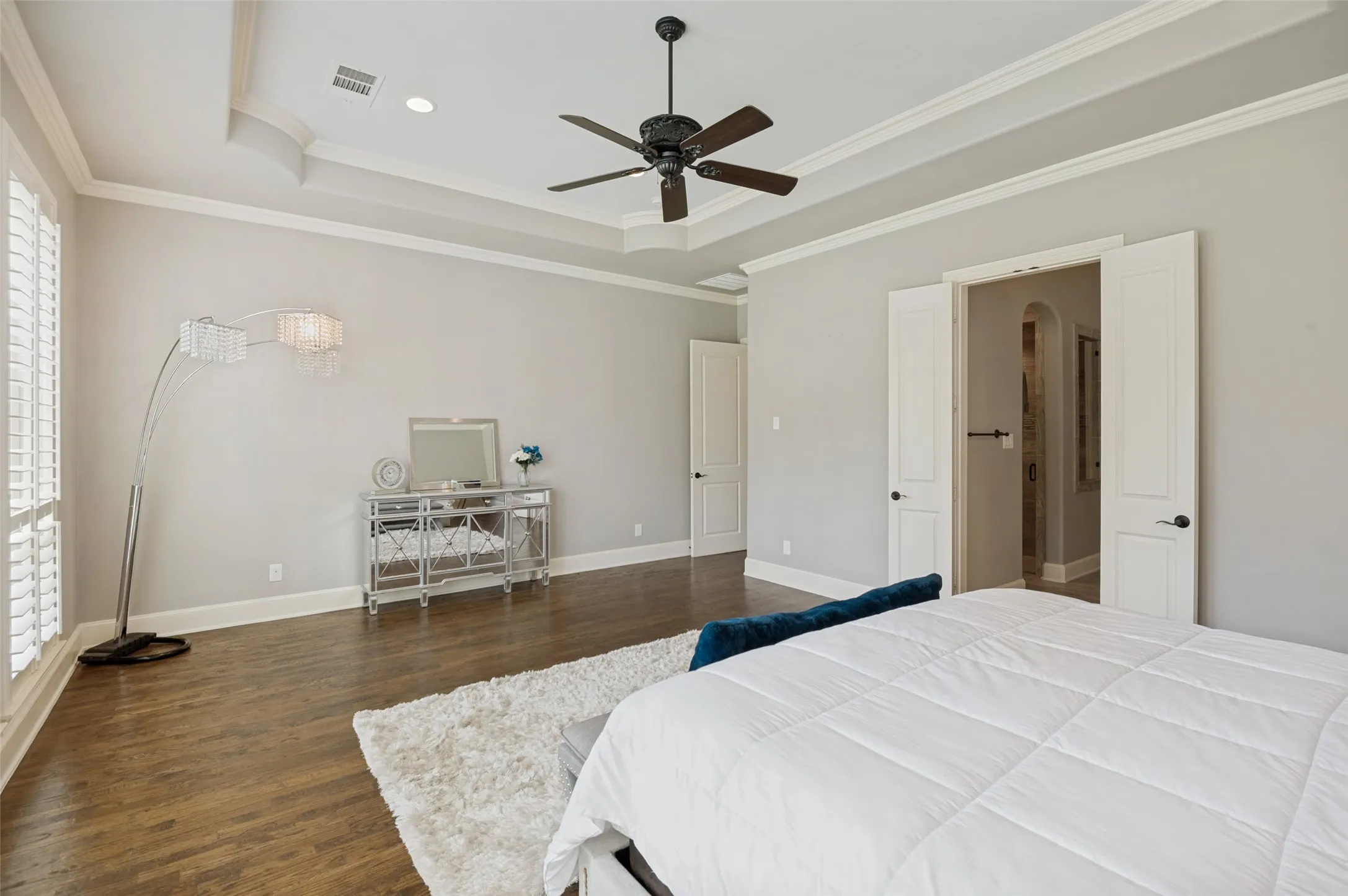 The sheer size of this luxurious primary suite immediately sets it apart, offering an expansive retreat with ample room for a private sitting area, reading nook, or additional furnishings.