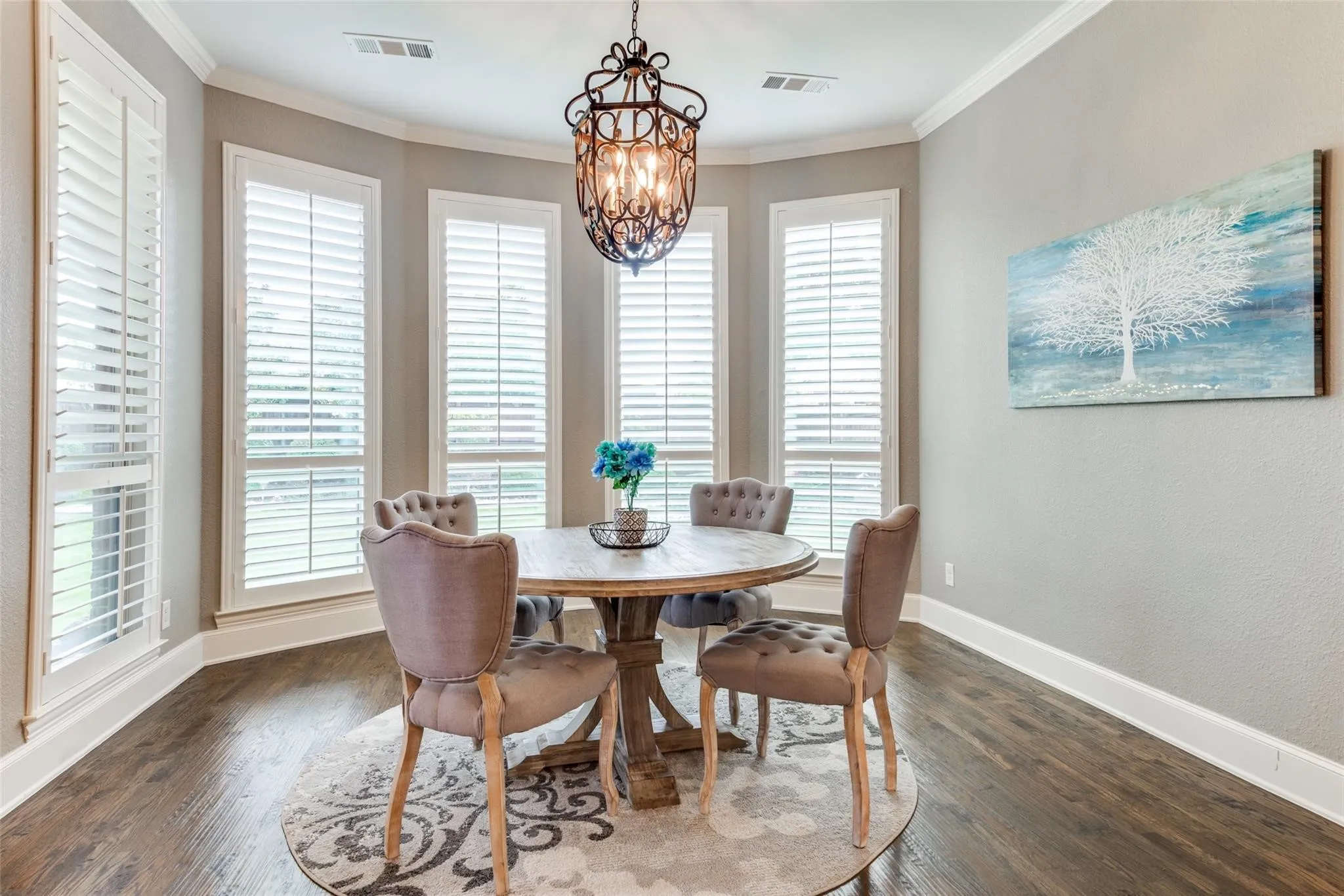 The generous layout easily accommodates family meals and casual gatherings, while rich hardwood floors and a designer chandelier add warmth and sophistication. Conveniently positioned adjacent to the gourmet kitchen, this sun-filled dining space seamlessly blends comfort and style, making it the perfect place to start your morning or enjoy relaxed evenings with family and friends.