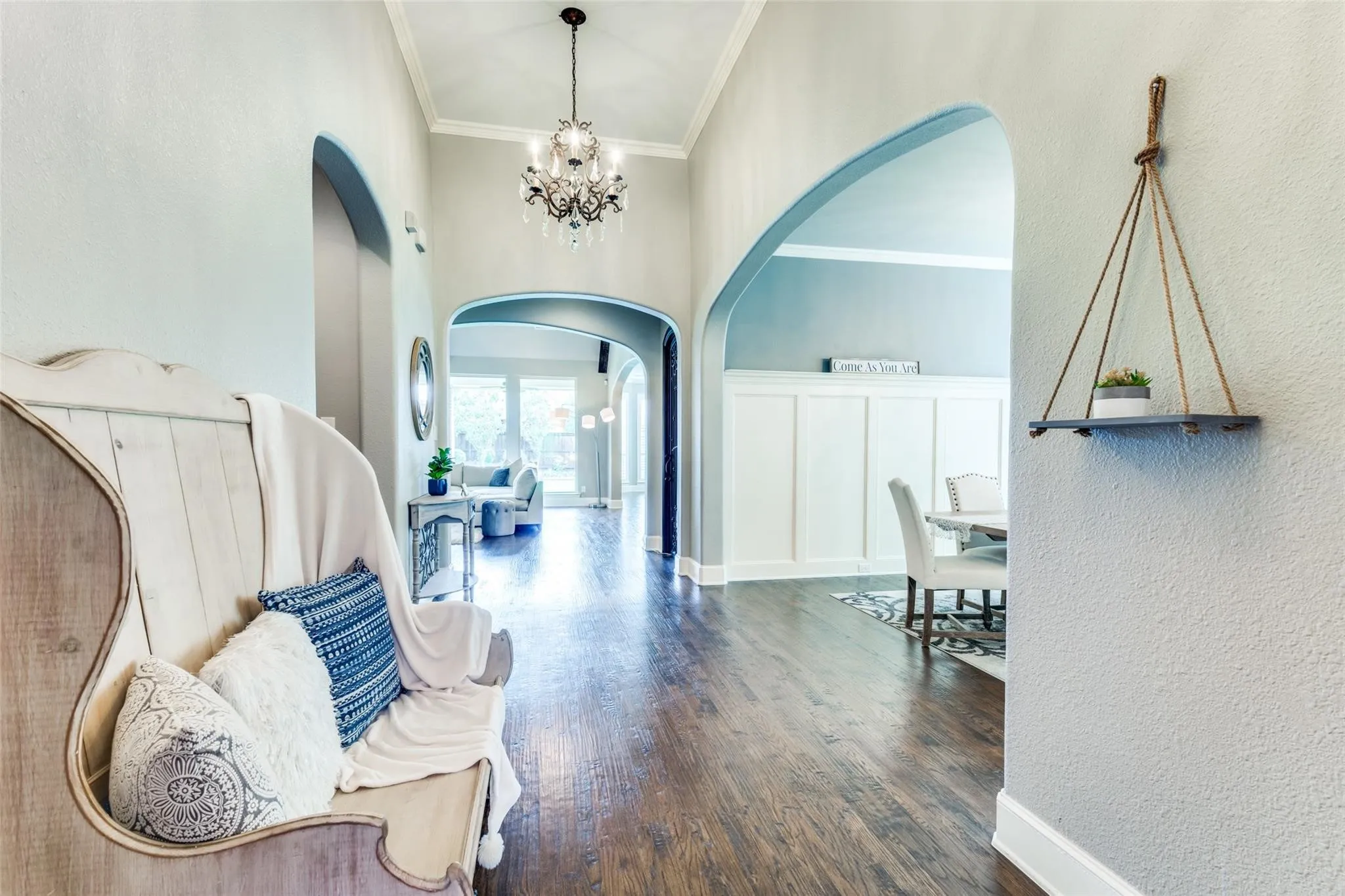 Step inside and be welcomed by an elegant entry showcasing rich solid hand-scraped hardwood floors, soaring ceilings, and timeless architectural details throughout. Expansive arched hallways create a grand sense of flow while natural light pours through the home.