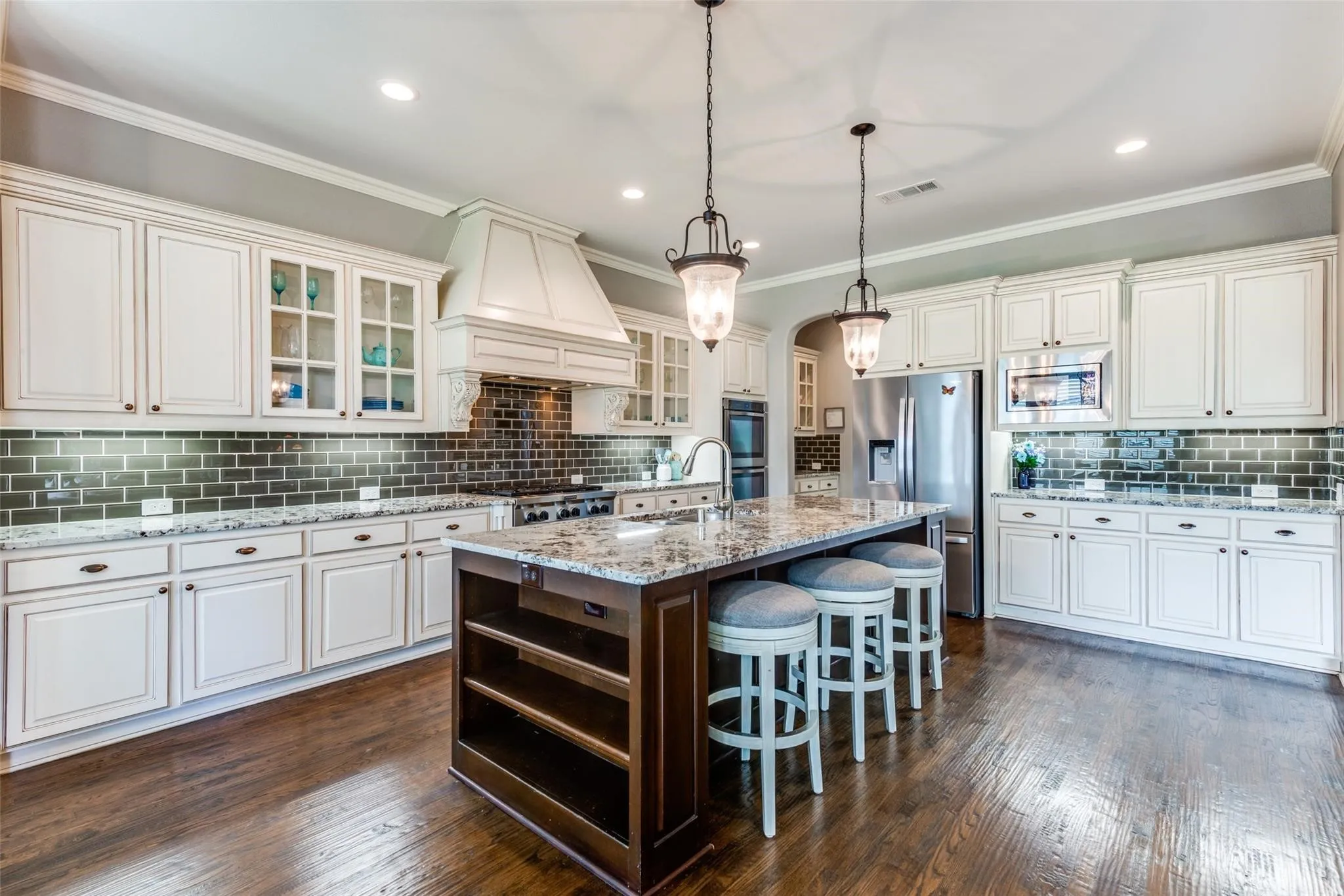 This gourmet kitchen is a chef’s dream, thoughtfully designed with both elegance and functionality in mind. An expansive center island serves as the heart of the space, offering abundant prep space, seating, and storage for effortless entertaining.