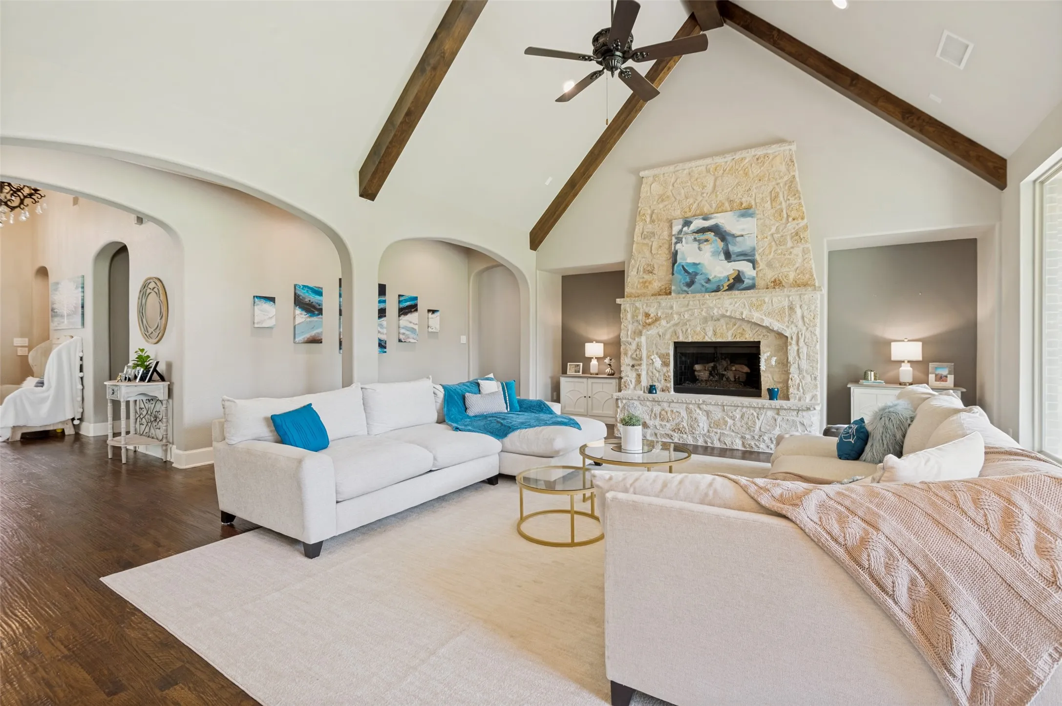 A floor-to-ceiling stone fireplace serves as a stunning focal point, anchoring the space with timeless character and charm.